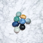 A colorful set of 8 milky round glass pebbles in multicolor, arranged on a white background – ideal for decoration, aquariums, and vases
