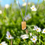 A handcrafted Yellow Aventurine stone pendant with a polished oval gemstone set in a sleek metal frame, suitable for men and women
