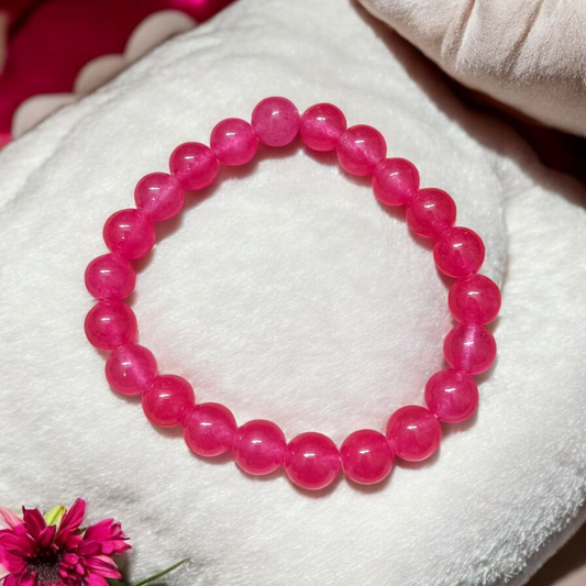 A handcrafted stretchable Pink Onyx bracelet with 8mm light pink beads arranged in a circle on a white background