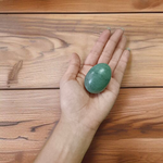 A natural greenish-black Shivling stone, hand-carved and polished, ideal for Tulsi plants, garden altars, and temple worship