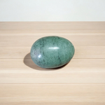 A natural greenish-black Shivling stone, hand-carved and polished, ideal for Tulsi plants, garden altars, and temple worship