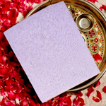 A neatly folded pure white cotton cloth used for Hindu rituals and poojas, displayed on a wooden surface