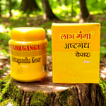 Ashtaganda kesar kumkum containers placed with puja items like diya, flowers, and yantra paper