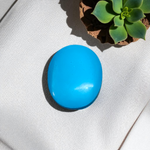 Close-up image of an Original Turquoise (Firoza) Stone with smooth polish and natural color patterns, ideal for healing and confidence