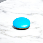 Close-up image of an Original Turquoise (Firoza) Stone with smooth polish and natural color patterns, ideal for healing and confidence