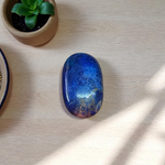 Close-up image of polished Lapis Lazuli stone by MALAWALA showing deep blue color and natural gold flecks