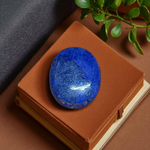 Close-up image of polished Lapis Lazuli stone by MALAWALA showing deep blue color and natural gold flecks