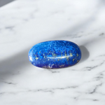 Close-up image of polished Lapis Lazuli stone by MALAWALA showing deep blue color and natural gold flecks