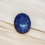 Close-up image of polished Lapis Lazuli stone by MALAWALA showing deep blue color and natural gold flecks