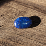 Close-up image of polished Lapis Lazuli stone by MALAWALA showing deep blue color and natural gold flecks