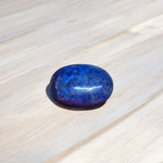 Close-up image of polished Lapis Lazuli stone by MALAWALA showing deep blue color and natural gold flecks