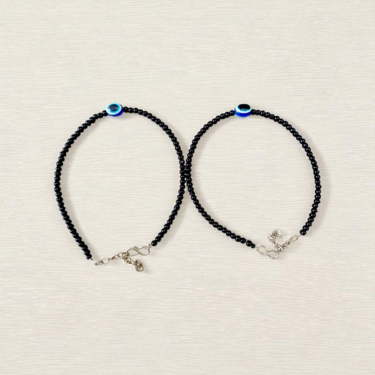 Elegant anklet with blue evil eye charm for girls and women, featuring adjustable chain and delicate bead detailing, designed for protection and style