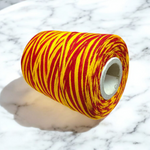 Extra large bundle of red Kalawa Moli thread, neatly rolled, with strands displayed beside for ceremonial use