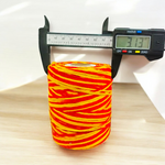 Extra large bundle of red Kalawa Moli thread, neatly rolled, with strands displayed beside for ceremonial use