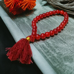 Handcrafted Red Hakik Mala made with natural Red Agate beads in 27+1 and 108+1 variants, placed on a wooden surface with lab certificate