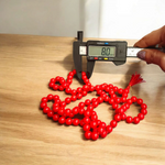 Handcrafted Red Hakik Mala made with natural Red Agate beads in 27+1 and 108+1 variants, placed on a wooden surface with lab certificate