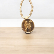 Image of Hanuman Ji Locket strung in Tulsi Mala with natural wood beads, placed on a white background