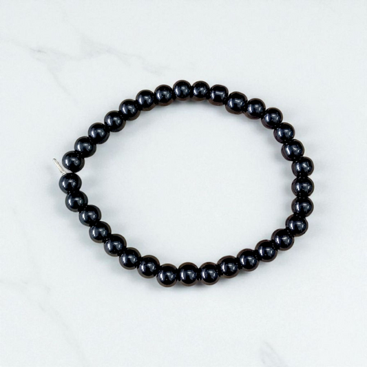 Image of a Black Agate (Black Hakik) bracelet with 6mm round beads arranged on a stretchable cord