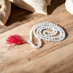 Image showing a set of 4 Jaap Malas – Rudraksha, White Sandalwood, Sphatik, and Red Sandalwood – neatly arranged on a traditional spiritual cloth