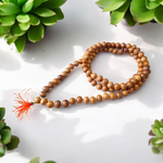 Image showing a set of 4 Jaap Malas – Rudraksha, White Sandalwood, Sphatik, and Red Sandalwood – neatly arranged on a traditional spiritual cloth