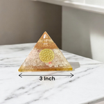 Lab certified orgone pyramid featuring white healing stones, a copper coil, and clear resin body designed for energy balancing and meditation