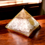 Lab certified orgone pyramid featuring white healing stones, a copper coil, and clear resin body designed for energy balancing and meditation