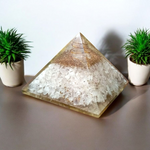 Lab certified orgone pyramid featuring white healing stones, a copper coil, and clear resin body designed for energy balancing and meditation