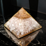 Lab certified orgone pyramid featuring white healing stones, a copper coil, and clear resin body designed for energy balancing and meditation