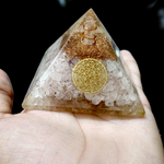 Lab certified orgone pyramid featuring white healing stones, a copper coil, and clear resin body designed for energy balancing and meditation