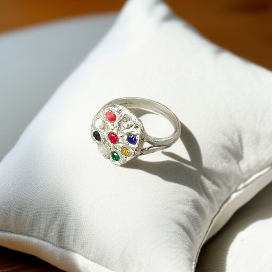 Oval-shaped gold-plated Navratan ring with nine colorful gemstones set in a tortoise design for spiritual and astrological benefits