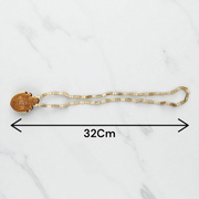 Shri Radha Locket strung in a handcrafted Tulsi Mala with secure screw lock, photographed on a neutral background