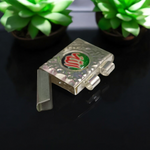 Silver square taweez set with Bhojpatra sheets arranged neatly on a decorative cloth background