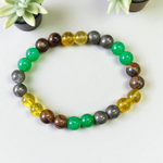Stretchable 8mm bead Money Magnet Bracelet made of Green Aventurine, Citrine, and Pyrite crystals, lab certified, placed on a neutral background