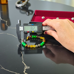 Stretchable 8mm bead Money Magnet Bracelet made of Green Aventurine, Citrine, and Pyrite crystals, lab certified, placed on a neutral background