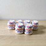 White chandan paste container used for tilak, puja, and religious ceremonies