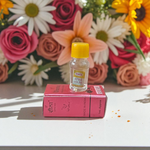 2ML bottle of Gulab Attar by Veena, a handcrafted rose perfume for spiritual and daily use, placed with rose petals