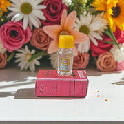2ML bottle of Gulab Attar by Veena, a handcrafted rose perfume for spiritual and daily use, placed with rose petals