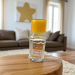 2ML bottle of Gulab Attar by Veena, a handcrafted rose perfume for spiritual and daily use, placed with rose petals