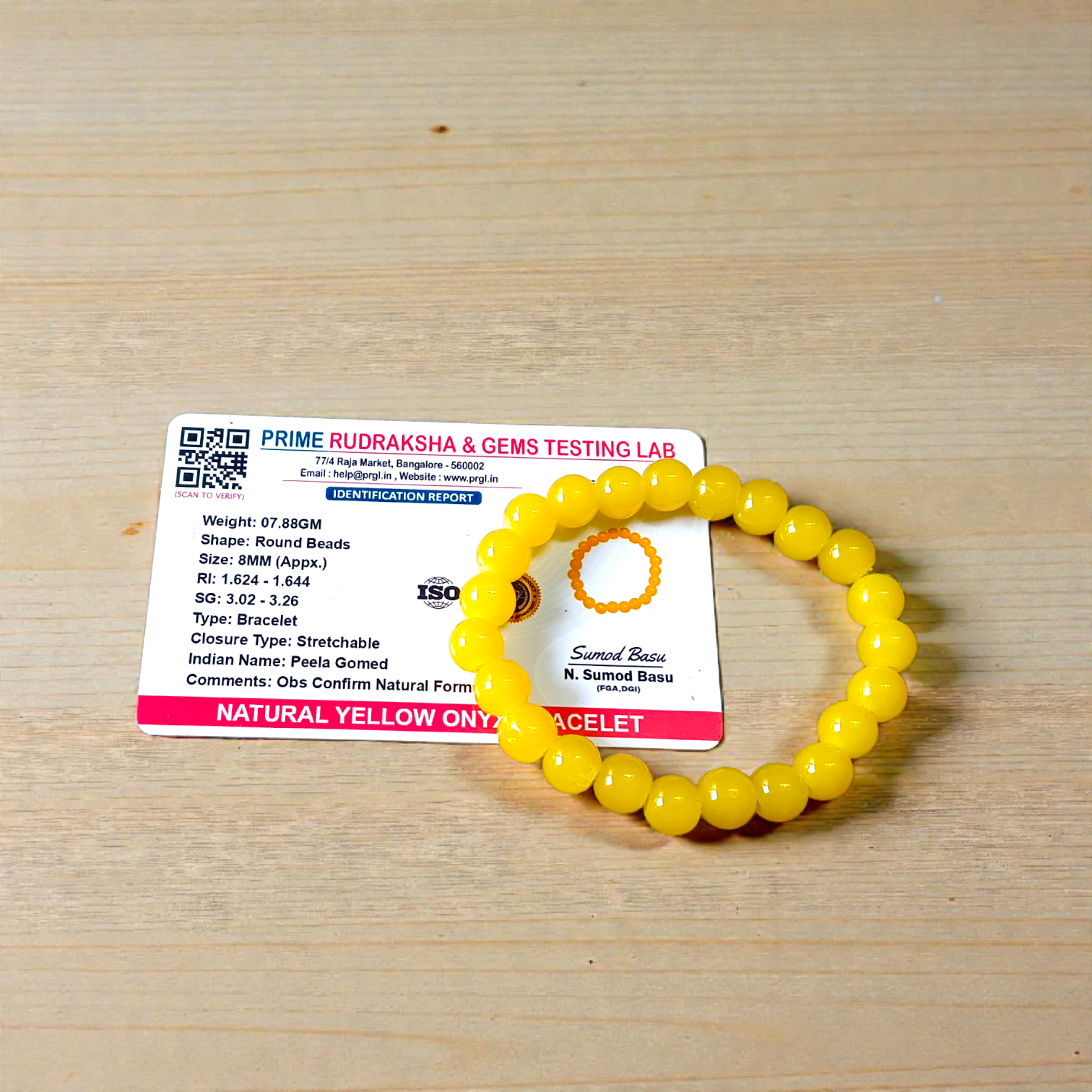Image of a stretchable Yellow Onyx bracelet with polished 8mm round beads arranged in a circle on a white or neutral background
