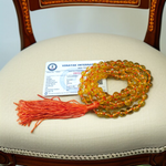 A 108+1 bead Citrine mala made from 8mm natural citrine crystals, used for meditation, japa, and spiritual practices