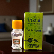 A 2ML bottle of Kewra Attar by Veena placed next to Kewra flowers, highlighting its traditional use in meditation and worship