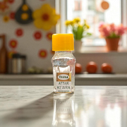 A 2ML bottle of Kewra Attar by Veena placed next to Kewra flowers, highlighting its traditional use in meditation and worship