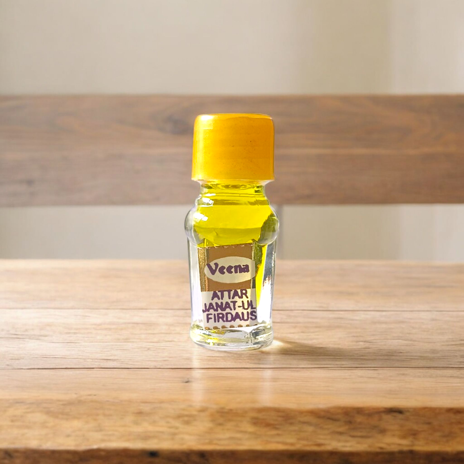 A 2ML roll-on bottle of Janat-UL-Firdaus Attar by Veena, placed alongside aromatic herbs and floral elements, symbolizing purity and spirituality