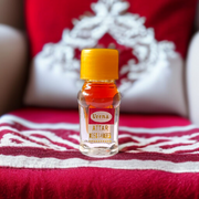 A 2ML roll-on bottle of Veena’s Musk Amber Attar placed elegantly with natural ingredients in the background, showcasing luxury and tradition