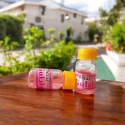 A 4ML roll-on bottle of Gulab Attar by Veena, displayed with rose petals around it, symbolizing purity, romance, and timeless floral elegance