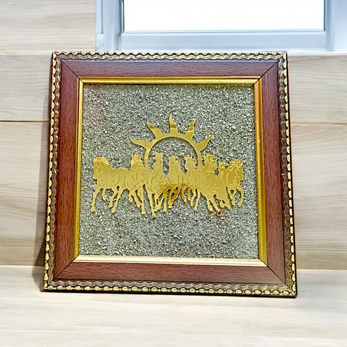 A 7x7 inch wooden Vastu frame featuring seven golden horses running toward the rising sun with a centrally placed Pyrite stone, ideal for wealth and energy correction