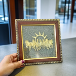 A 7x7 inch wooden Vastu frame featuring seven golden horses running toward the rising sun with a centrally placed Pyrite stone, ideal for wealth and energy correction