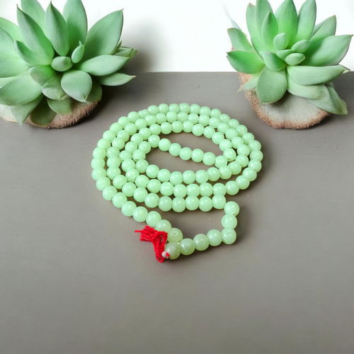 A Lab Certified Green Moti Mala made of 108+1 smooth, round green pearl beads, strung for japa, meditation, and spiritual healing