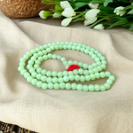 A Lab Certified Green Moti Mala made of 108+1 smooth, round green pearl beads, strung for japa, meditation, and spiritual healing