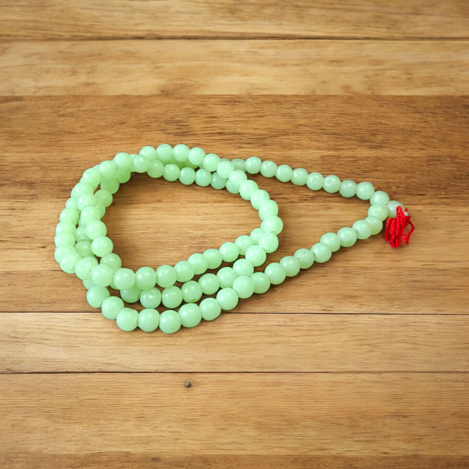 A Lab Certified Green Moti Mala made of 108+1 smooth, round green pearl beads, strung for japa, meditation, and spiritual healing